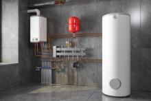 Picture of a white heat pump water heater in a grey room